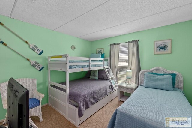 116 E Polaris Dr Unit 305, South Padre Island, TX 78597 - carpeted bedroom featuring a textured ceiling