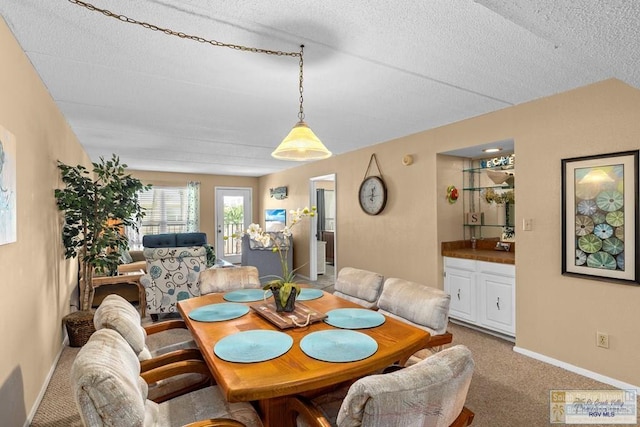 116 E Polaris Dr Unit 305, South Padre Island, TX 78597 - dining room featuring light colored carpet, a textured ceiling, and bar