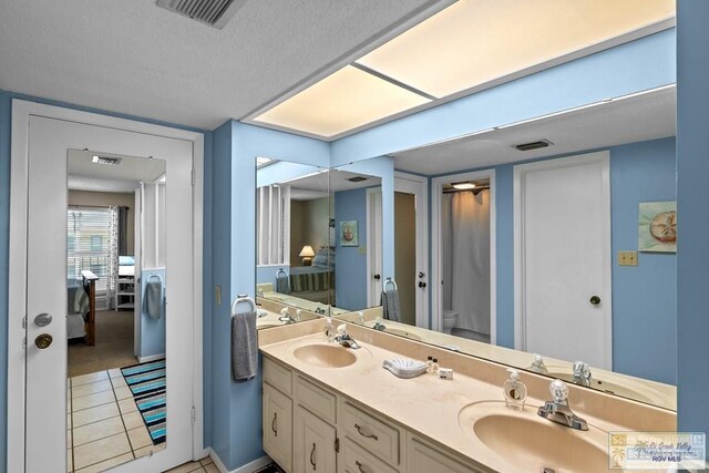 116 E Polaris Dr Unit 305, South Padre Island, TX 78597 - full bathroom with double vanity and tile patterned floors