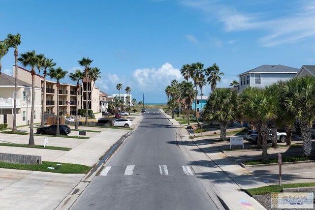 116 E Polaris Dr Unit 305, South Padre Island, TX 78597 - view of asphalt road featuring sidewalks, curbs, and a residential view