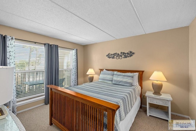 116 E Polaris Dr Unit 305, South Padre Island, TX 78597 - carpeted bedroom with a textured ceiling and baseboards