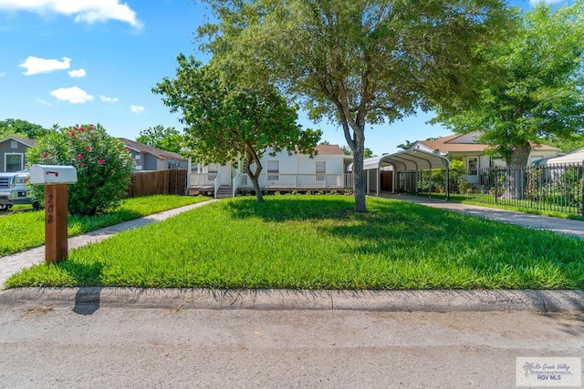 202 E Harding Ave, Harlingen, TX 78550 - obstructed view of property with a detached carport, concrete driveway, and a residential view