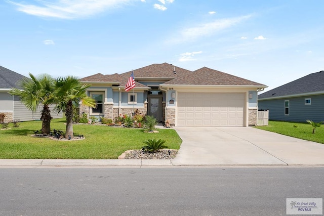 view of front of home featuring a front yard and a garage