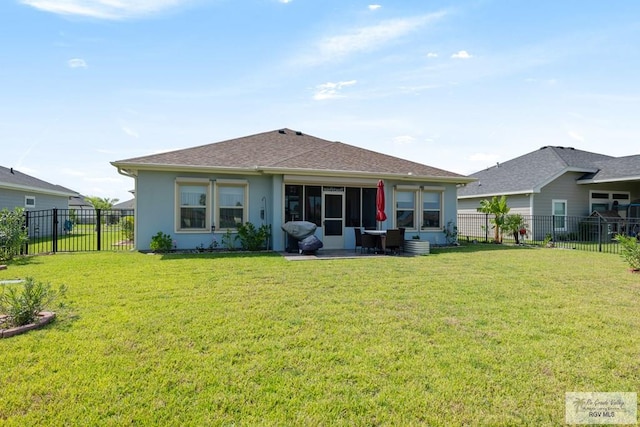 back of house with a sunroom and a yard