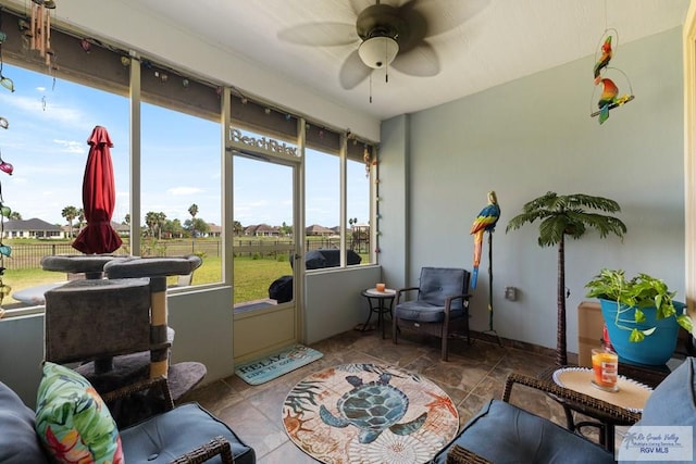 sunroom featuring ceiling fan