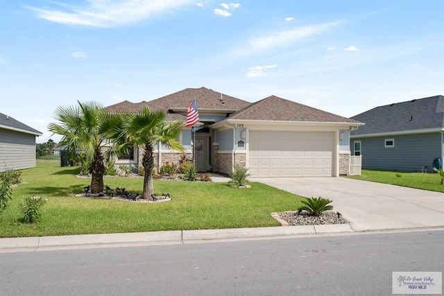 view of front facade featuring a garage and a front lawn