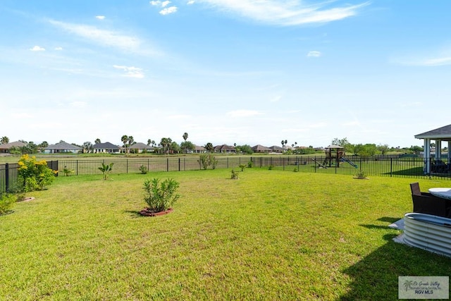 view of yard featuring a rural view and a playground