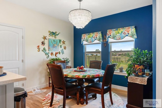 dining room featuring hardwood / wood-style flooring and a notable chandelier