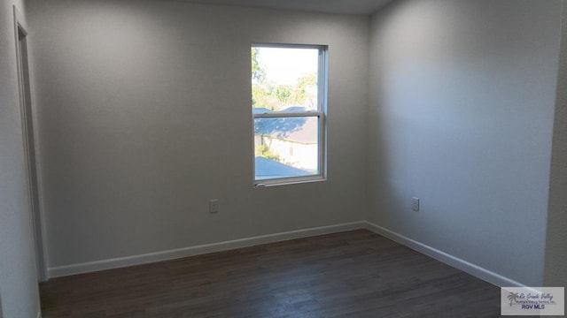 empty room featuring dark hardwood / wood-style flooring