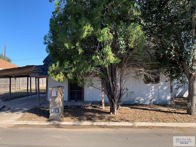 obstructed view of property featuring a carport