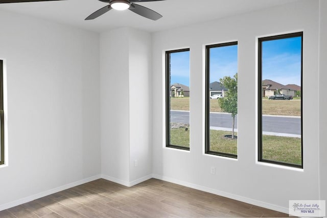 spare room with ceiling fan and light hardwood / wood-style floors