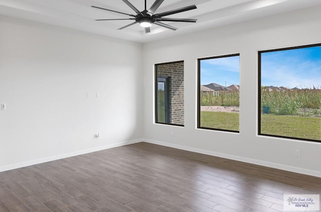 empty room with ceiling fan and dark wood-type flooring