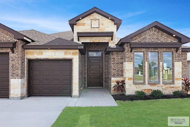 view of front facade with a garage and a front lawn