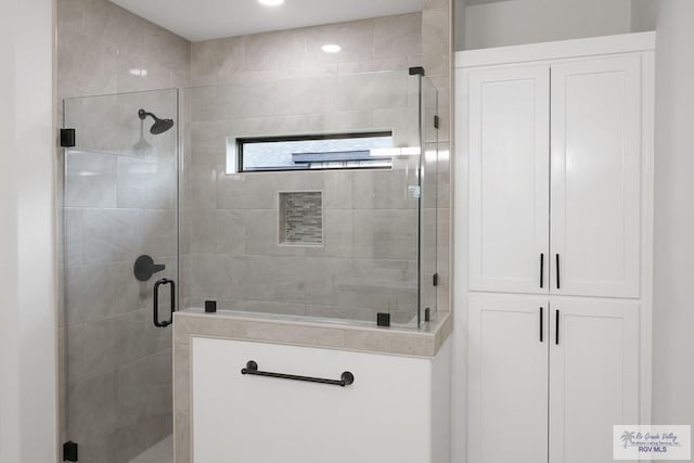 bathroom featuring a shower with door