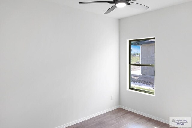 empty room with hardwood / wood-style flooring and ceiling fan