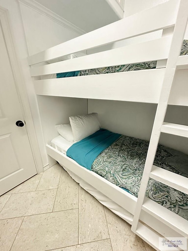 107 E Palm St Unit B, South Padre Island, TX 78597 - tiled bedroom featuring crown molding