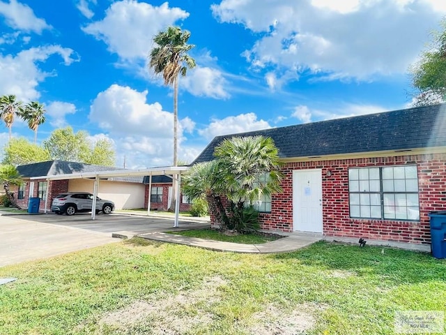 ranch-style house with a carport and a front lawn