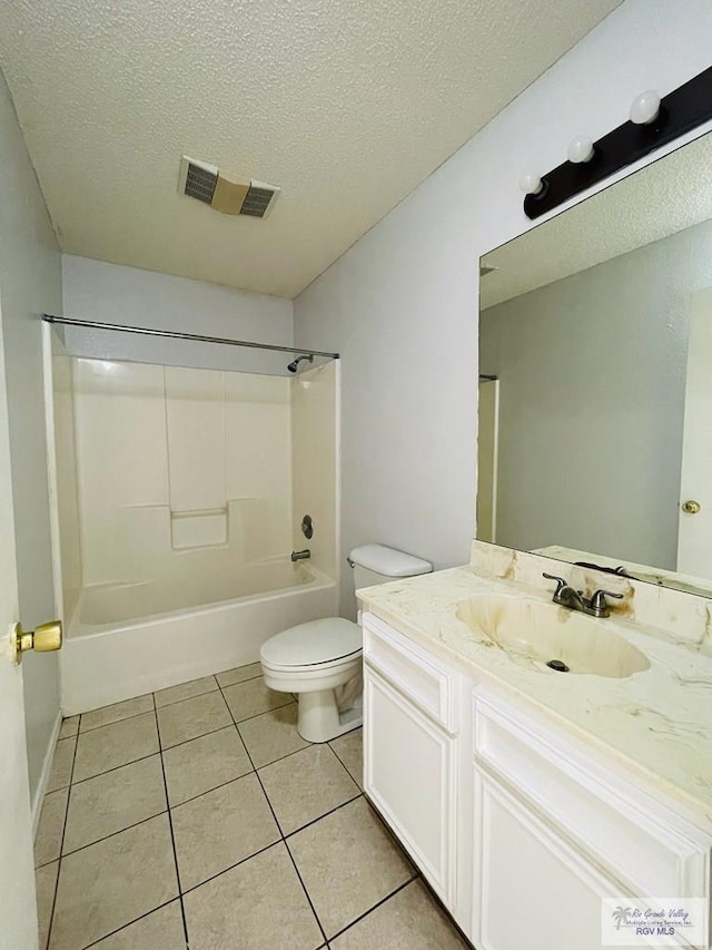 full bathroom featuring a textured ceiling, vanity, bathing tub / shower combination, tile patterned flooring, and toilet