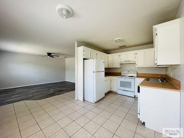 kitchen featuring a textured ceiling, white appliances, ceiling fan, sink, and white cabinetry