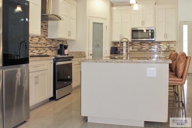 3512 Westcreek Dr, Brownsville, TX 78526 - kitchen with appliances with stainless steel finishes, wall chimney range hood, tasteful backsplash, and light stone counters
