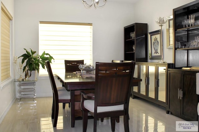 3512 Westcreek Dr, Brownsville, TX 78526 - dining room featuring healthy amount of natural light, light wood-style floors, and a chandelier