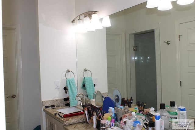 full bathroom featuring vanity and tiled shower