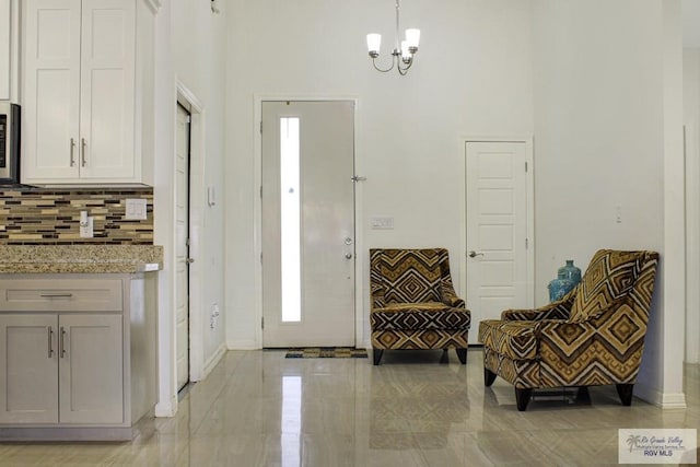 3512 Westcreek Dr, Brownsville, TX 78526 - foyer entrance with a chandelier and baseboards