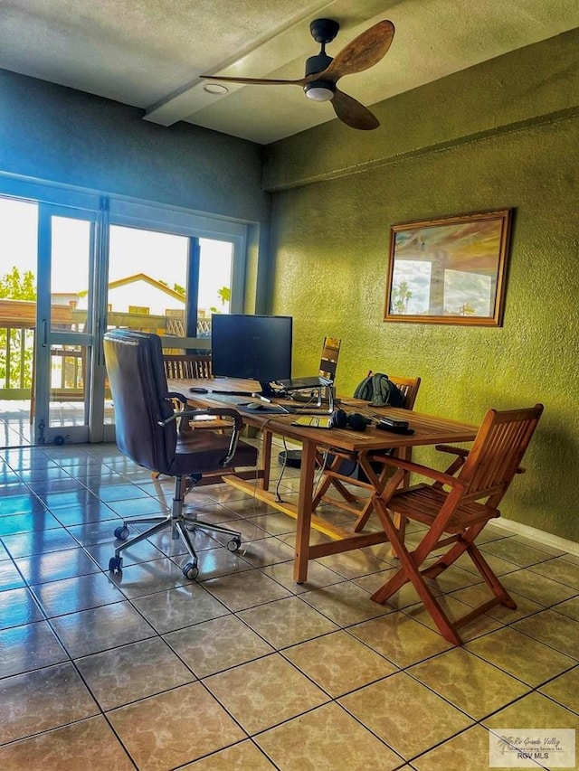 office space featuring tile patterned flooring, ceiling fan, and a textured ceiling