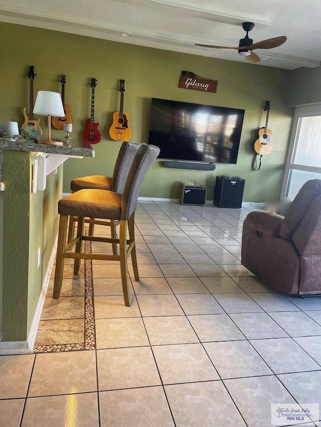 tiled living room with ceiling fan