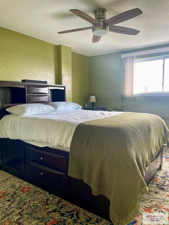 bedroom featuring a textured ceiling and ceiling fan