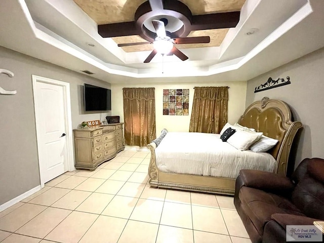 bedroom with a raised ceiling, light tile patterned floors, ceiling fan, and baseboards