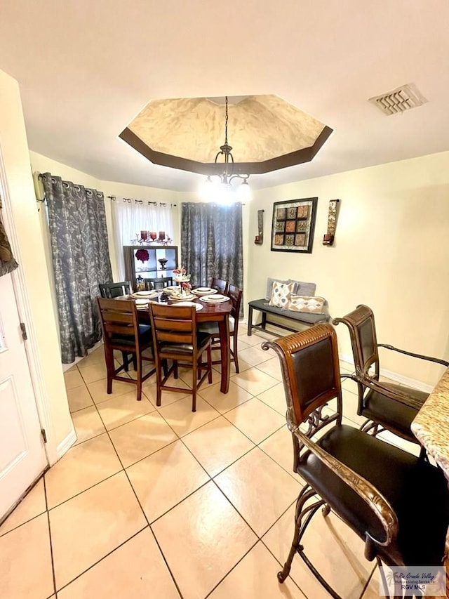dining room with light tile patterned flooring and a chandelier