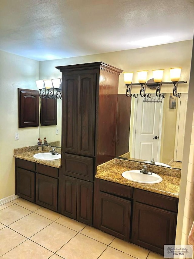 bathroom featuring tile patterned floors and two vanities