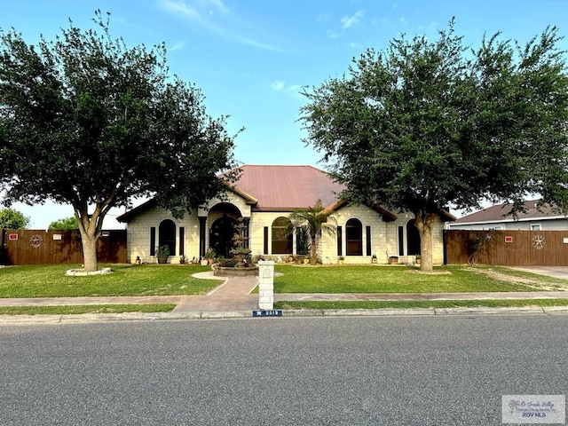 view of front of home with stone siding and metal roof