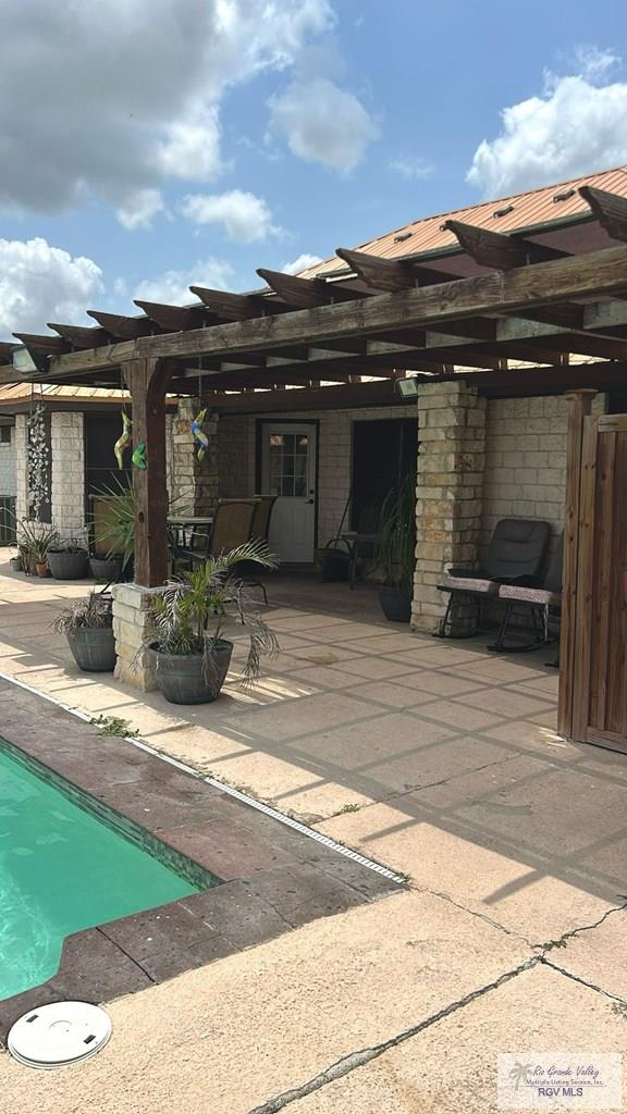 view of patio / terrace featuring a pergola and an outdoor pool