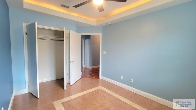 3429 E Country Club Dr, Edinburg, TX 78542 - unfurnished bedroom with a closet, light tile patterned floors, a raised ceiling, baseboards, and visible vents