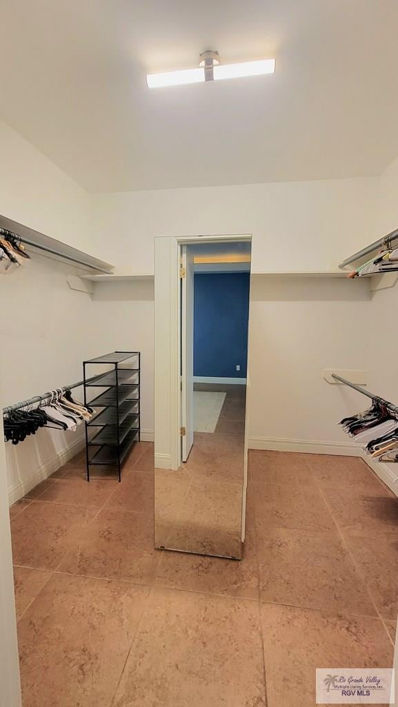 3429 E Country Club Dr, Edinburg, TX 78542 - walk in closet with light tile patterned floors