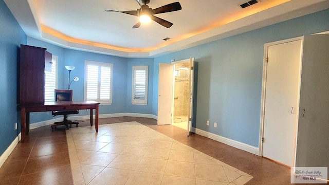 3429 E Country Club Dr, Edinburg, TX 78542 - home office featuring a tray ceiling, baseboards, visible vents, tile patterned flooring, and ceiling fan