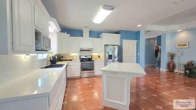 3429 E Country Club Dr, Edinburg, TX 78542 - kitchen featuring white cabinets, a center island, a sink, light countertops, and appliances with stainless steel finishes