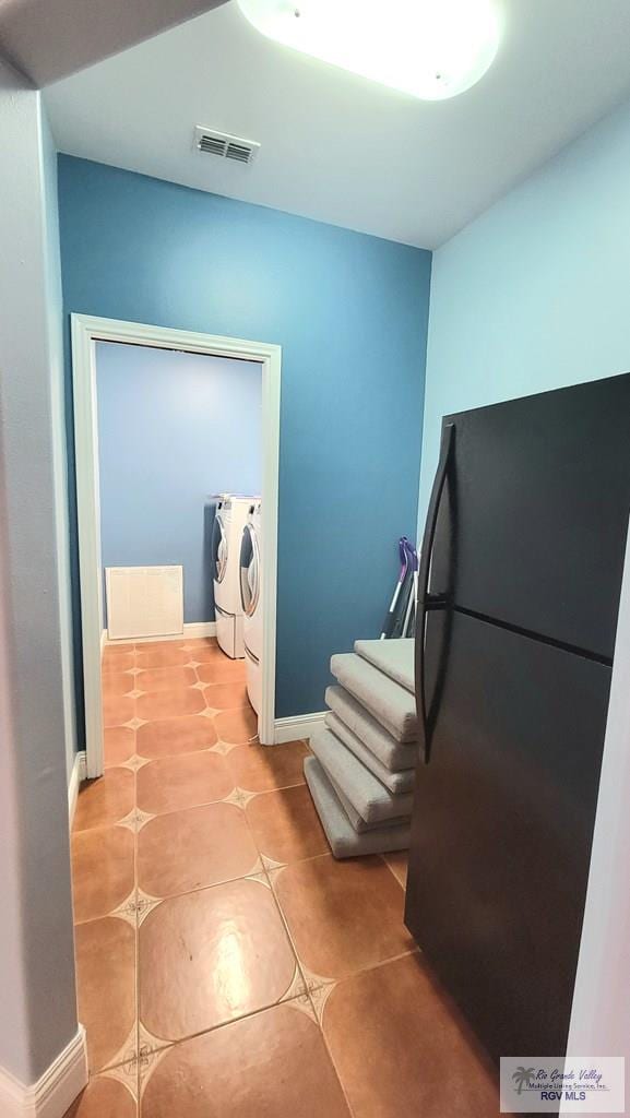 3429 E Country Club Dr, Edinburg, TX 78542 - corridor with washing machine and dryer, visible vents, baseboards, and light tile patterned floors