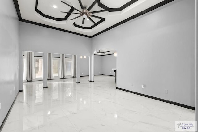 empty room with ceiling fan, crown molding, a high ceiling, and coffered ceiling