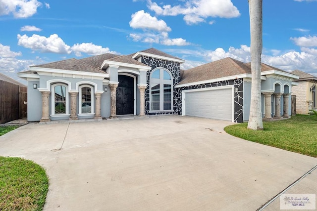 6948 Wild Olive Ln, Brownsville, TX 78526 - mediterranean / spanish-style home featuring a garage and a front lawn