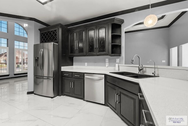 kitchen featuring sink, hanging light fixtures, a notable chandelier, crown molding, and appliances with stainless steel finishes