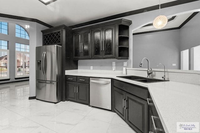6948 Wild Olive Ln, Brownsville, TX 78526 - kitchen featuring sink, hanging light fixtures, a notable chandelier, crown molding, and appliances with stainless steel finishes