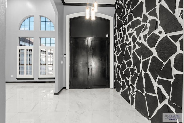 entryway featuring crown molding