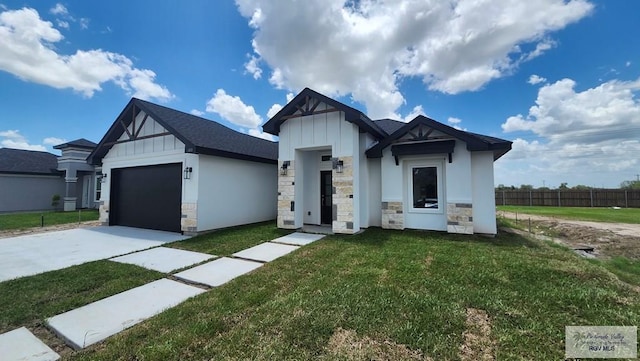 1418 Stirrup Cir, San Benito, TX 78586 - view of front facade with driveway, stone siding, an attached garage, and board and batten siding