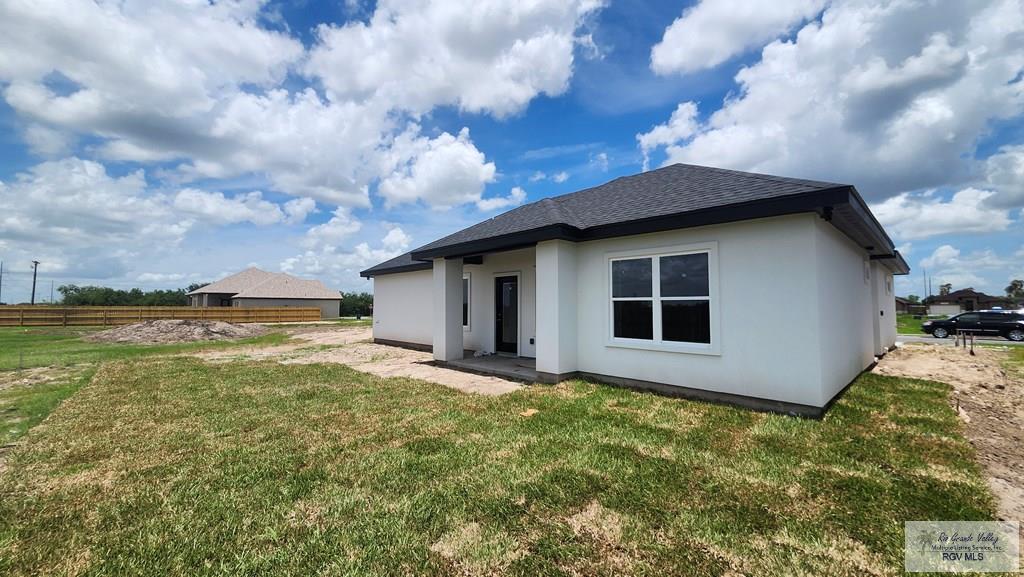 1418 Stirrup Cir, San Benito, TX 78586 - back of house featuring stucco siding and a shingled roof