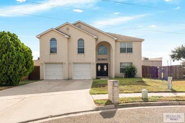 traditional home with a garage, a front lawn, driveway, and fence