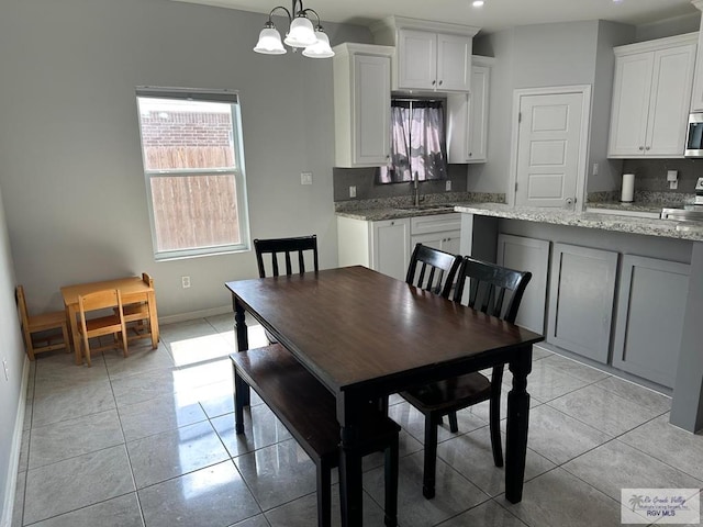 dining room with recessed lighting, baseboards, a chandelier, and light tile patterned floors