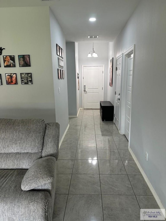hallway featuring visible vents and baseboards